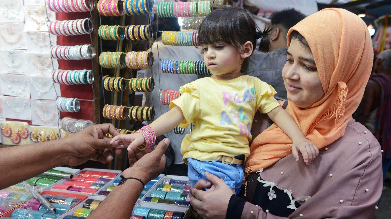 A woman with her daughter shops for bangles at a market for the upcoming Eid-ul-Fitr festival, in Kolkata on Sunday. (ANI Photo)