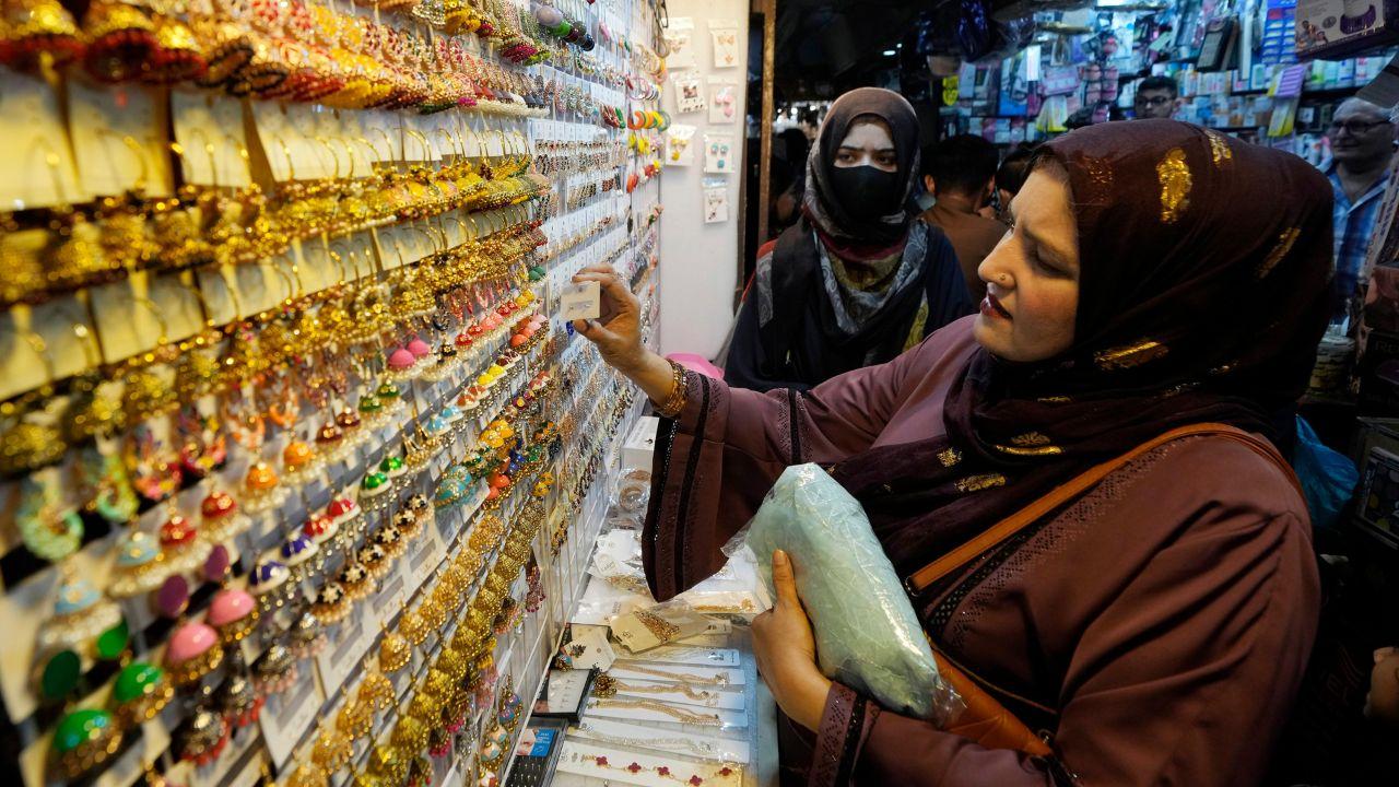Women browse traditional artificial jewellery while they visit a market to shop for the upcoming Eid al-Fitr celebrations, in Karachi, Pakistan, Sunday. (AP/PTI)