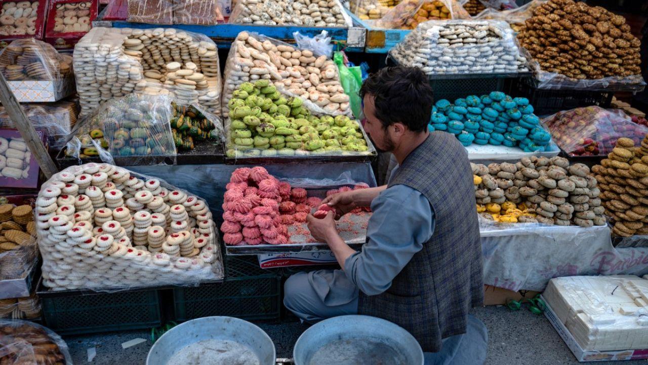 An Afghan vendor waiting for customers prepares local cookies called ‘kulcha’ ahead of Eid al-Fitr at a market in Kabul. (Photo by Wakil KOHSAR / AFP)