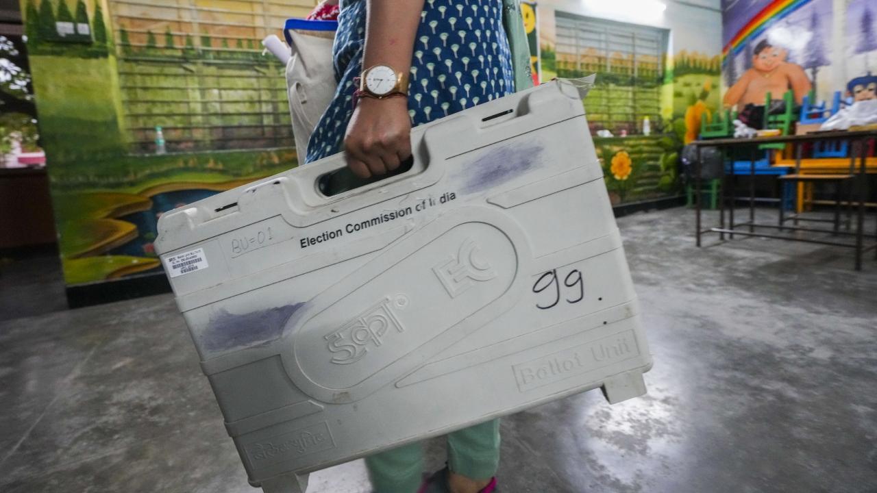 An election officer carries a sealed EVM after the voting concluded for the second phase of Lok Sabha elections 2024. Pic/PTI