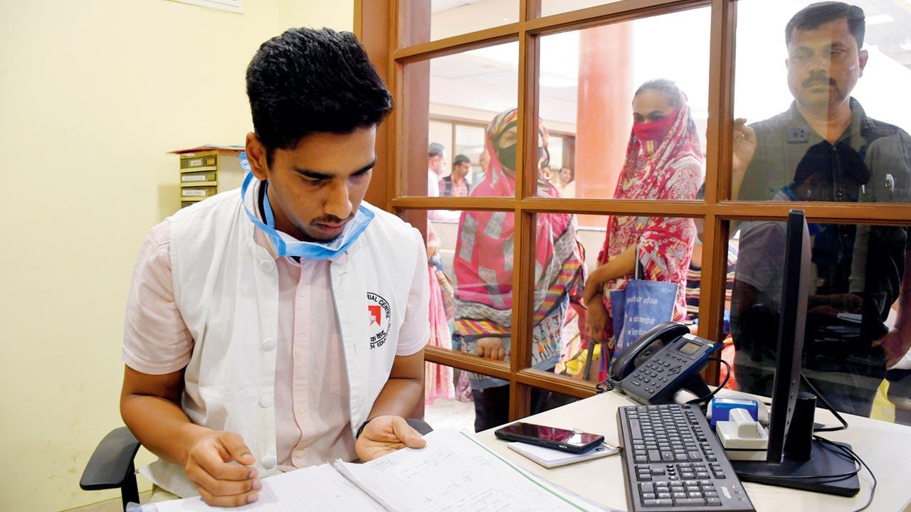 Siddhant Shilwan, a Kevat assistant at ACTREC Kharghar scans documents as patients eagerly await their turn. Shilwan says he applied for the programme last year after experiencing the life of a caregiver when his father was ailing. Pics/Kirti Surve Parade