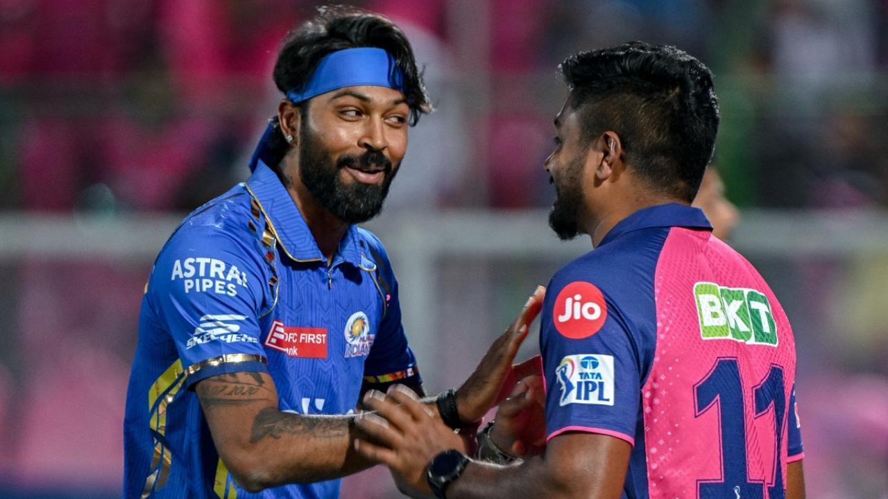 Mumbai Indians` captain Hardik Pandya and his Rajasthan Royals` counterpart Sanju Samson (R) talk with each other before start of the match (Pic: AFP)