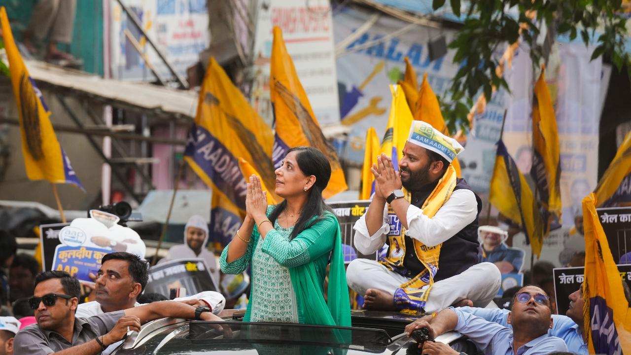Jailed Delhi Chief Minister Arvind Kejriwal's wife Sunita Kejriwal greets supporters during an election roadshow in support of Aam Aadmi Party's (AAP) candidate from East Delhi constituency Kuldeep Kumar for the Lok Sabha polls. Pic/PTI