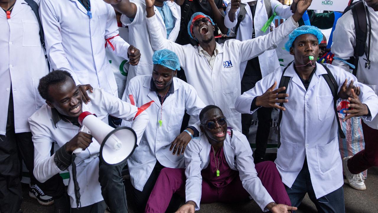 Kenyan doctors chant as they march towards the health ministry headquarters