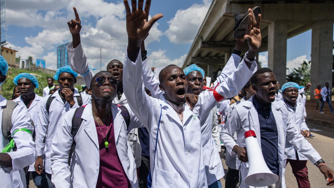 Doctors, chanting slogans for change, march towards Nairobi's health ministry headquarters, their voices echoing through the streets