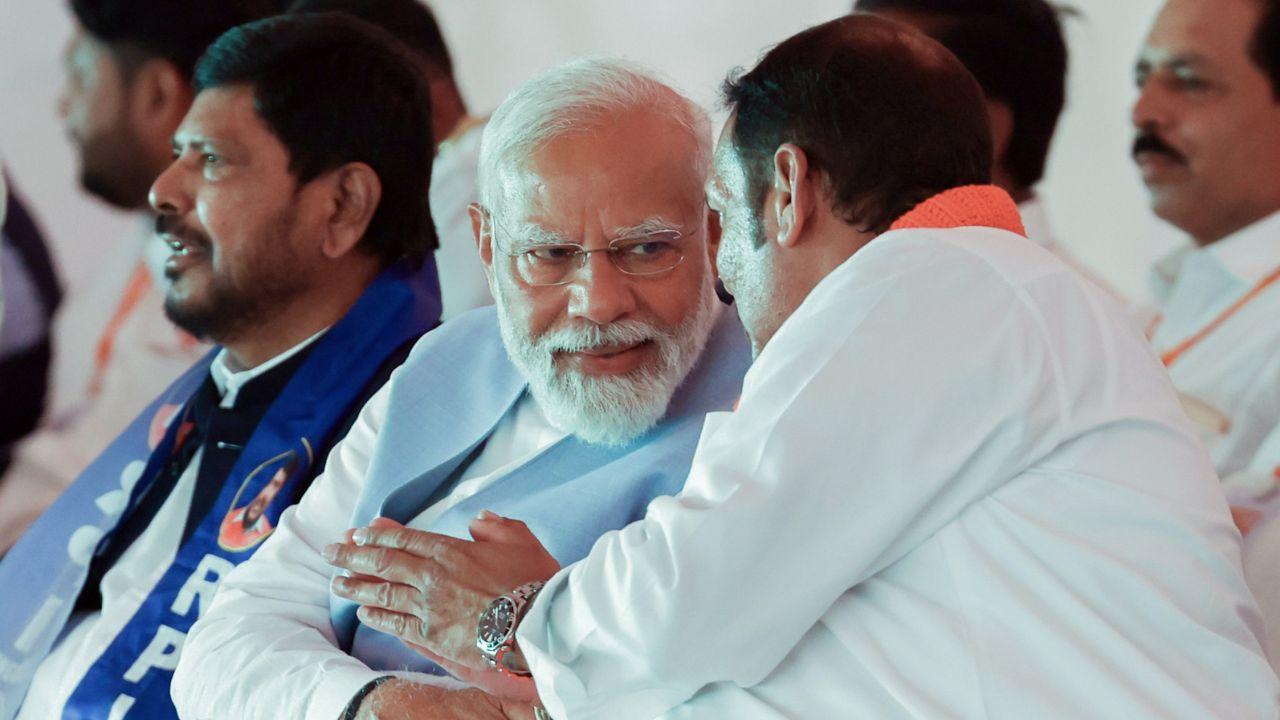 Prime Minister Narendra Modi seen conversing with BJP Rajya Sabha MP Udayanraje Bhosale during a public meeting ahead of the Lok Sabha elections, in Satara, Maharashtra on Monday. (ANI Photo)