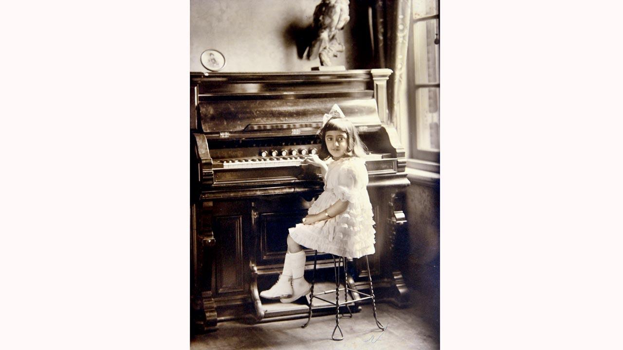As a little girl on her piano in Kobe, Japan