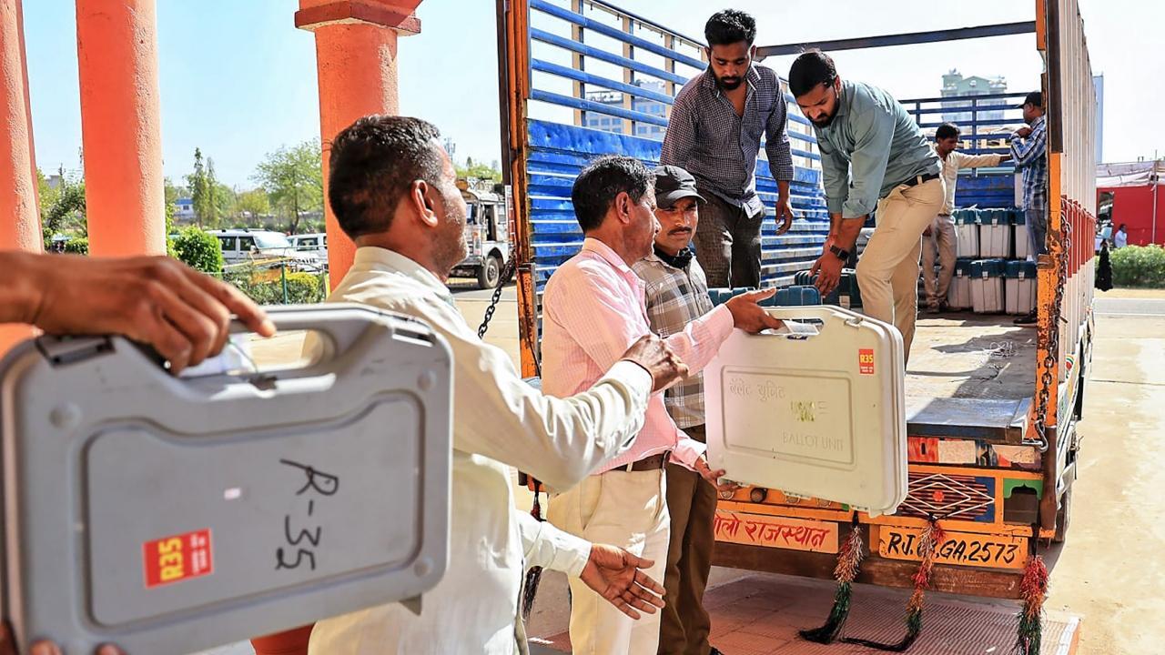 Polling officials unload EVMs, other election material on the eve of the first phase of Lok Sabha elections 2024. Pics/PTI