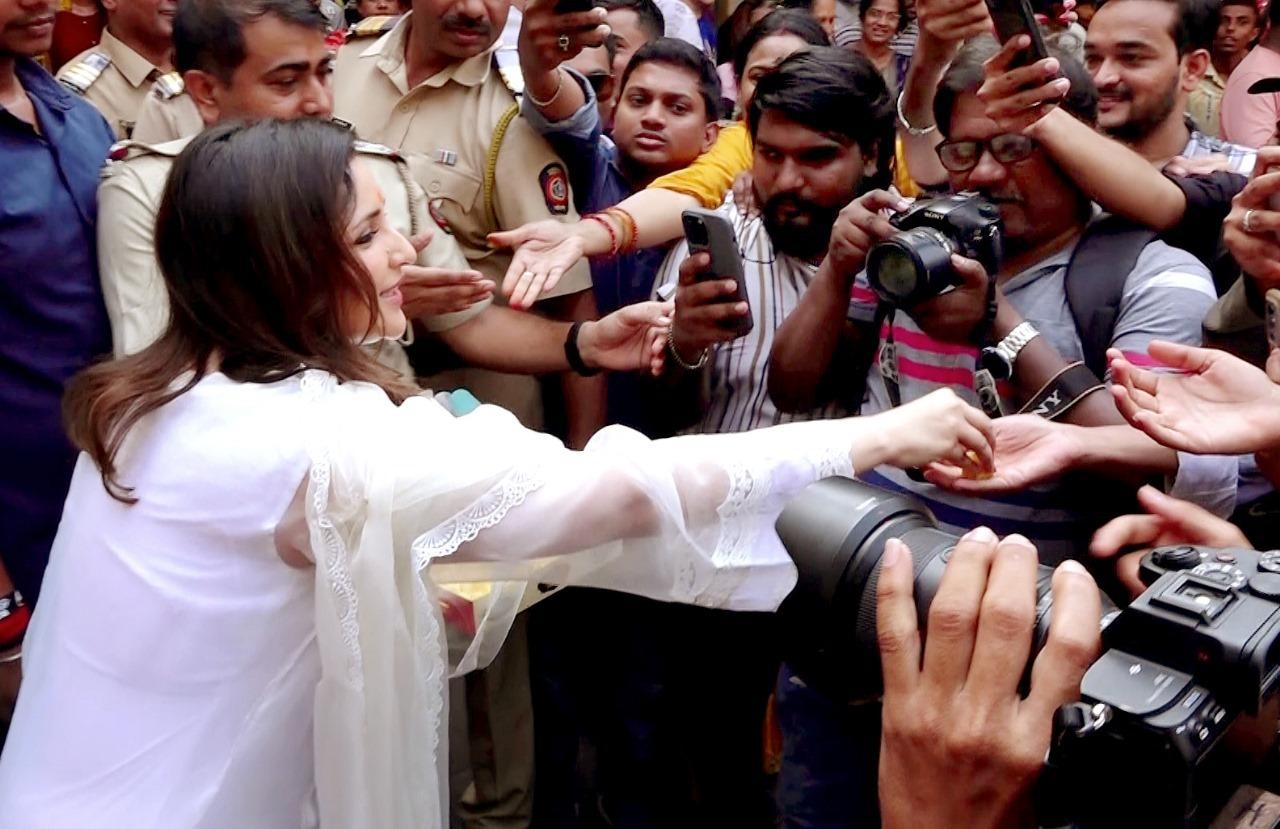 The actress was seen distributing prasad to the paparazzi who were present to take her pictures. 