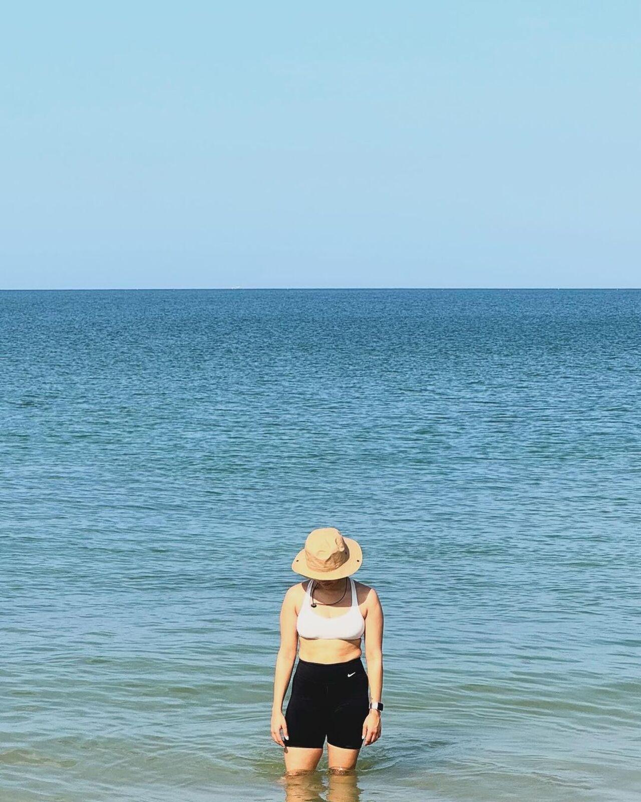 She also went for a swim to beat the heat and posed alongside the shore wearing a hat. 