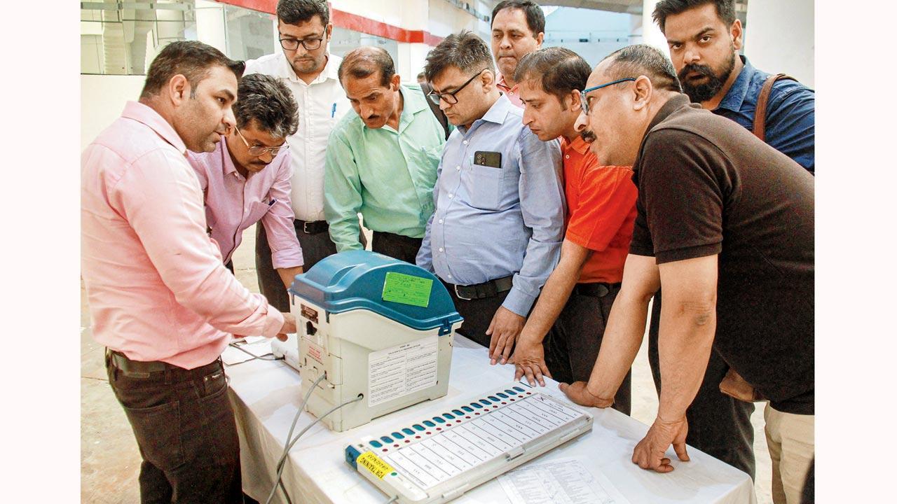 Electoral officer demonstrates the functioning of the EVM and VVPAT. Pic/PTI