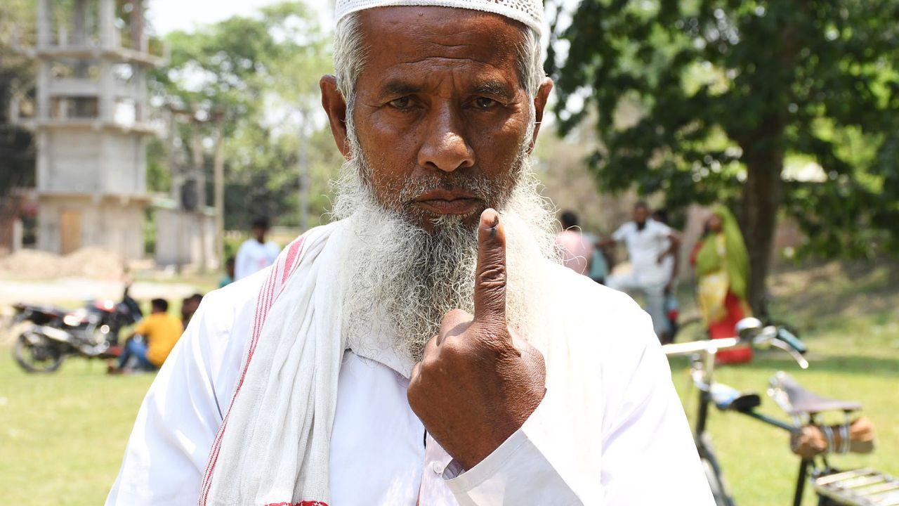  An elderly voter shows his ink-marked finger after casting his vote for the 2nd phase of Lok Sabha elections, in Morigaon district of Assam on Friday. (ANI Photo)