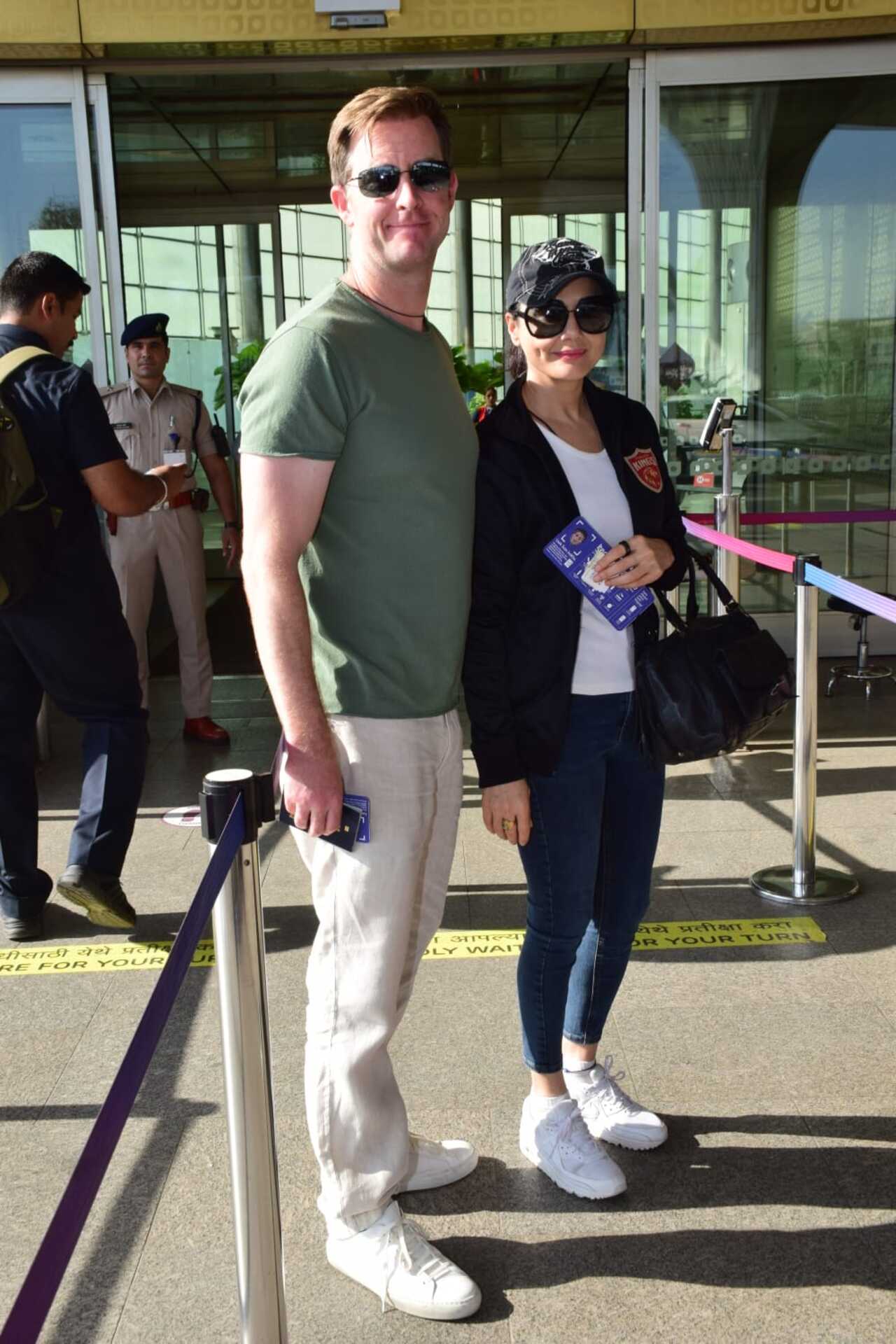 Preity Zinta and her husband Gene Goodenough strike a pose before they take their flight