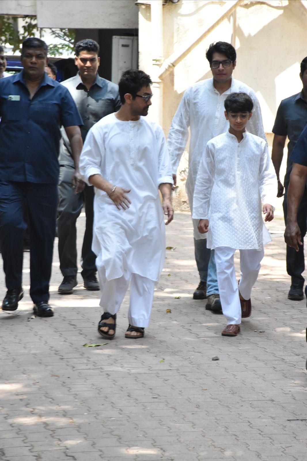Aamir Khan came outside his residence with his sons Junaid Khan and Azad, all three donning white kurtas. 