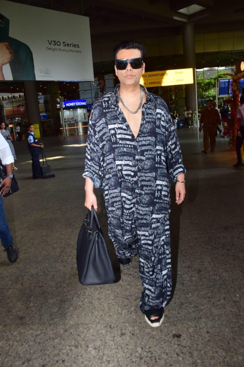 Karan Johar strutted through the airport in an extremely high fashion outfit