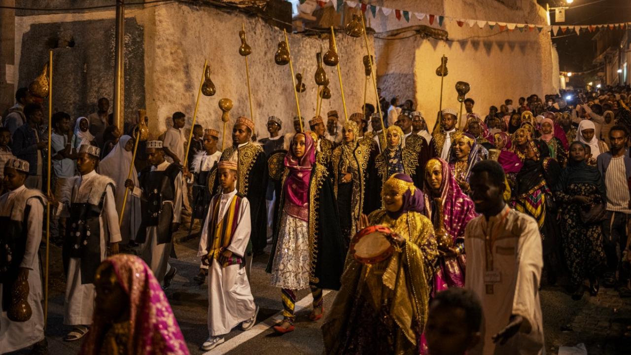 Young men and women dressed in traditional attires parade during the celebration for the Shuwalid festival in Harar on April 16, 2024. Shuwalid is an annual festival celebrated by the Harari people of Ethiopia and marks the end of six days of fasting to compensate omissions during Ramadan (Photo by Michele Spatari / AFP)