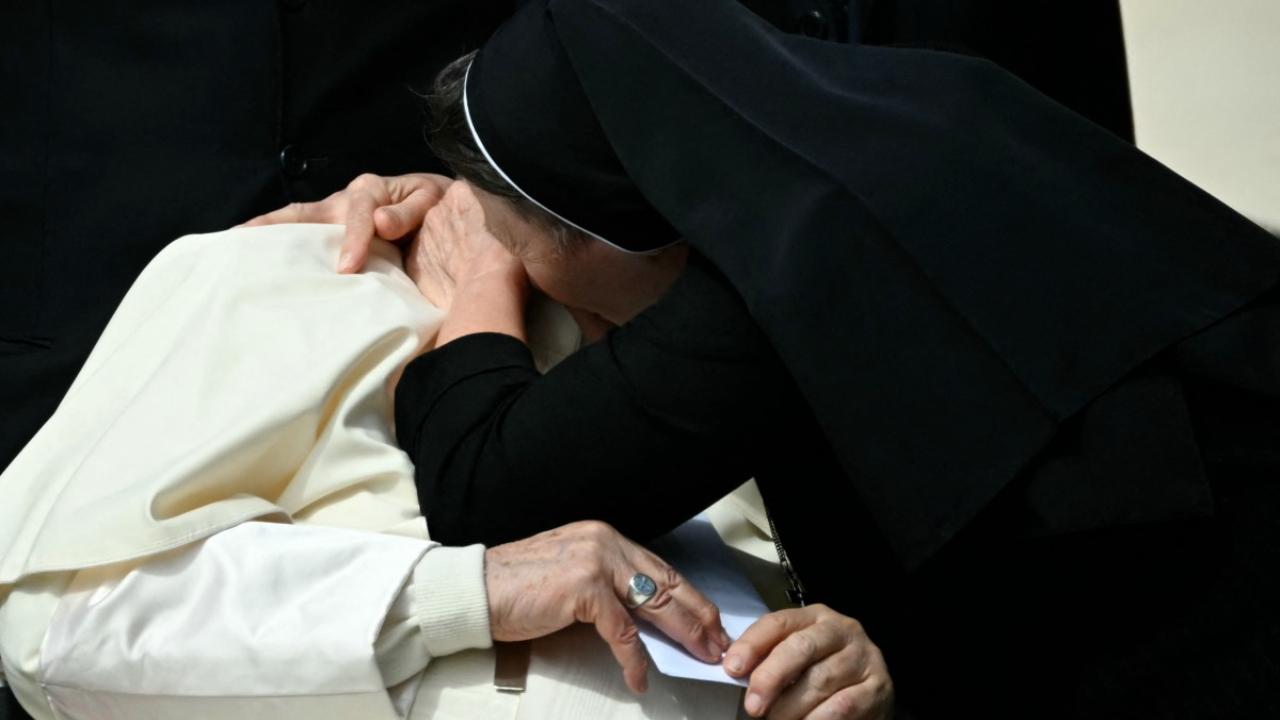 A nun embraces Pope Francis at the end of the weekly general audience on April 17, 2024 at St Peter's square in The Vatican (Photo by Filippo MONTEFORTE/AFP)