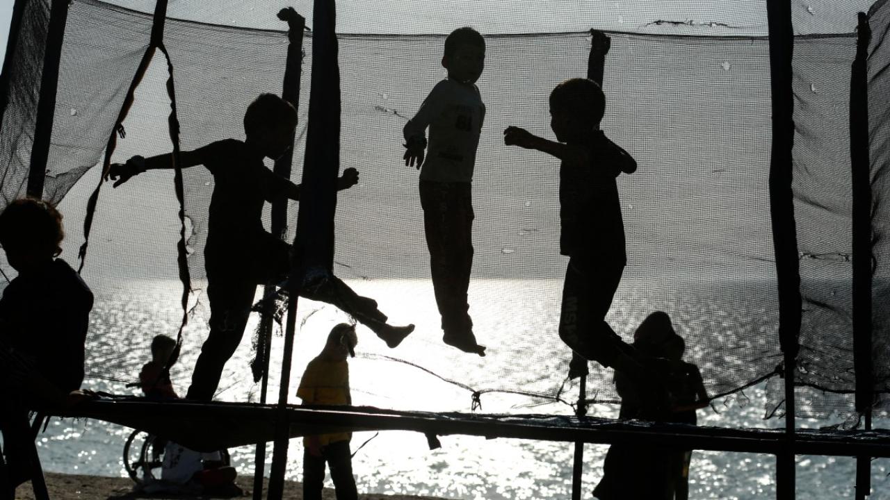 Palestinian children play on a trampolene on the beach in Deir el-Balah in the central Gaza Strip on April 17, 2024, amid Isarel's war in Gaza (Photo by AFP)
