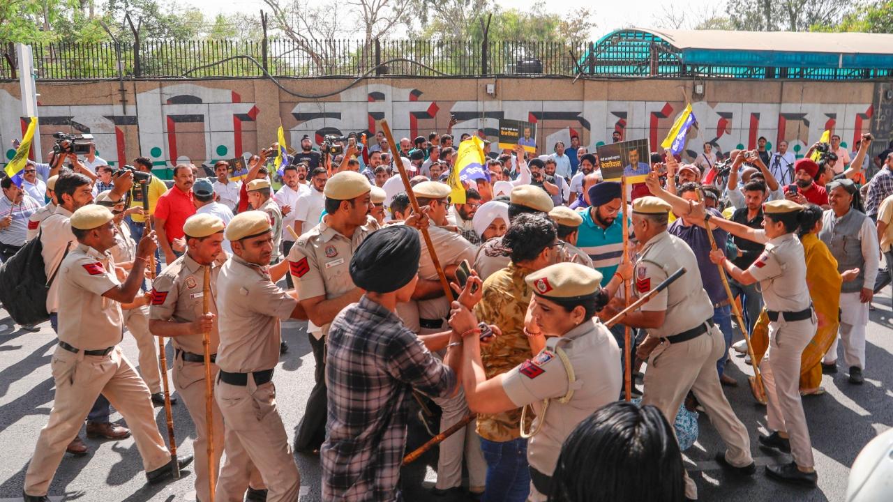 Scores of Aam Aadmi Party (AAP) workers, carrying party flags and wearing T-shirts with 'Main Bhi Kejriwal' printed on them, gathered outside the jail entrance