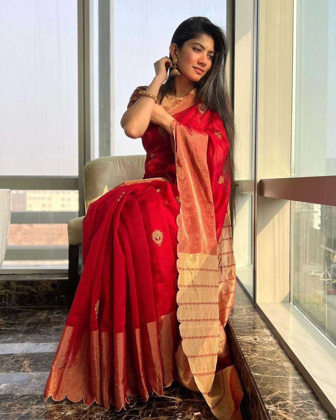The colour red is a safe bet for any festive occasion in India. Sai exudes elegance in this silk saree and paired it with traditional jewellery