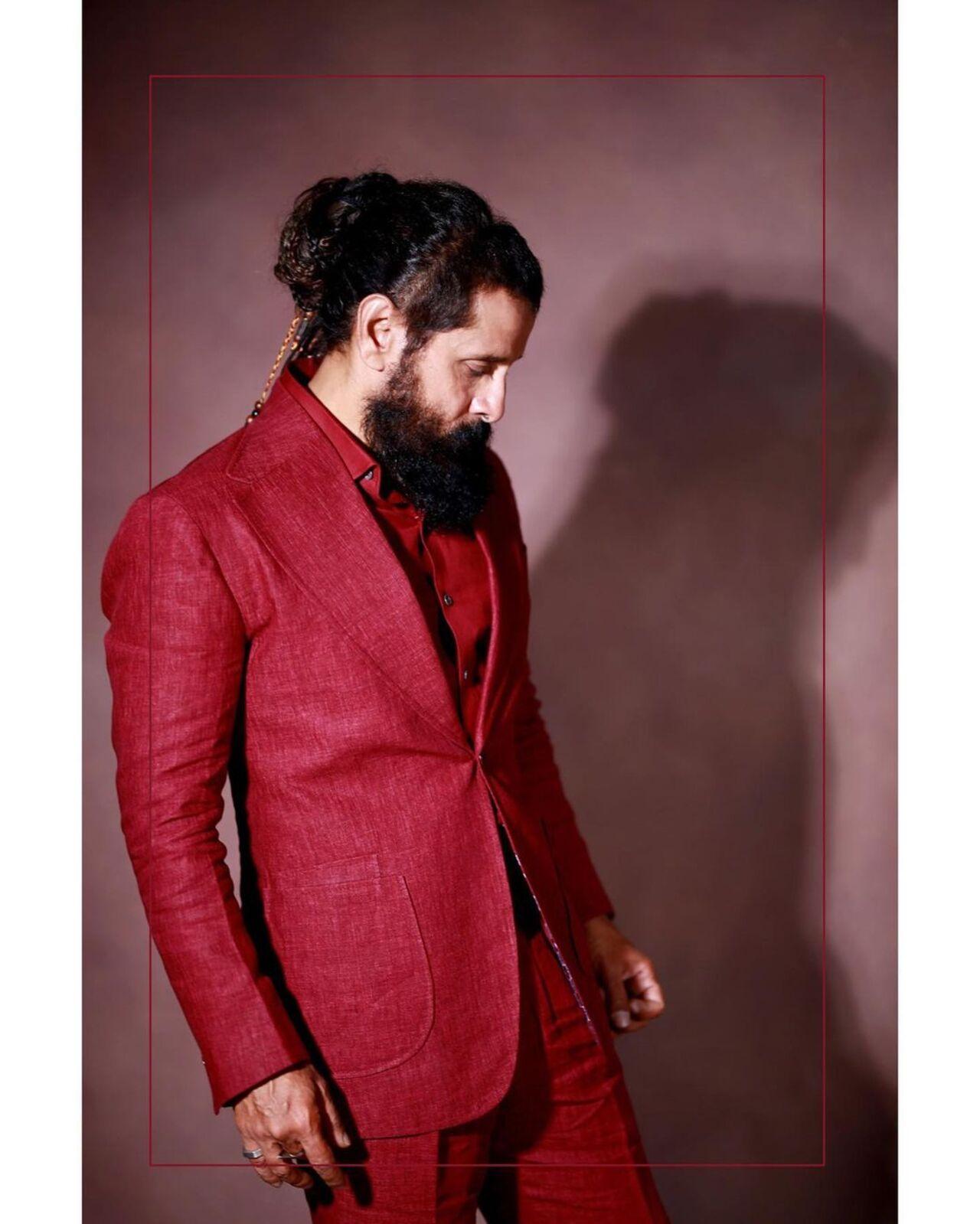 The actor rocks an all-red suit with his stylish beard and hair bun