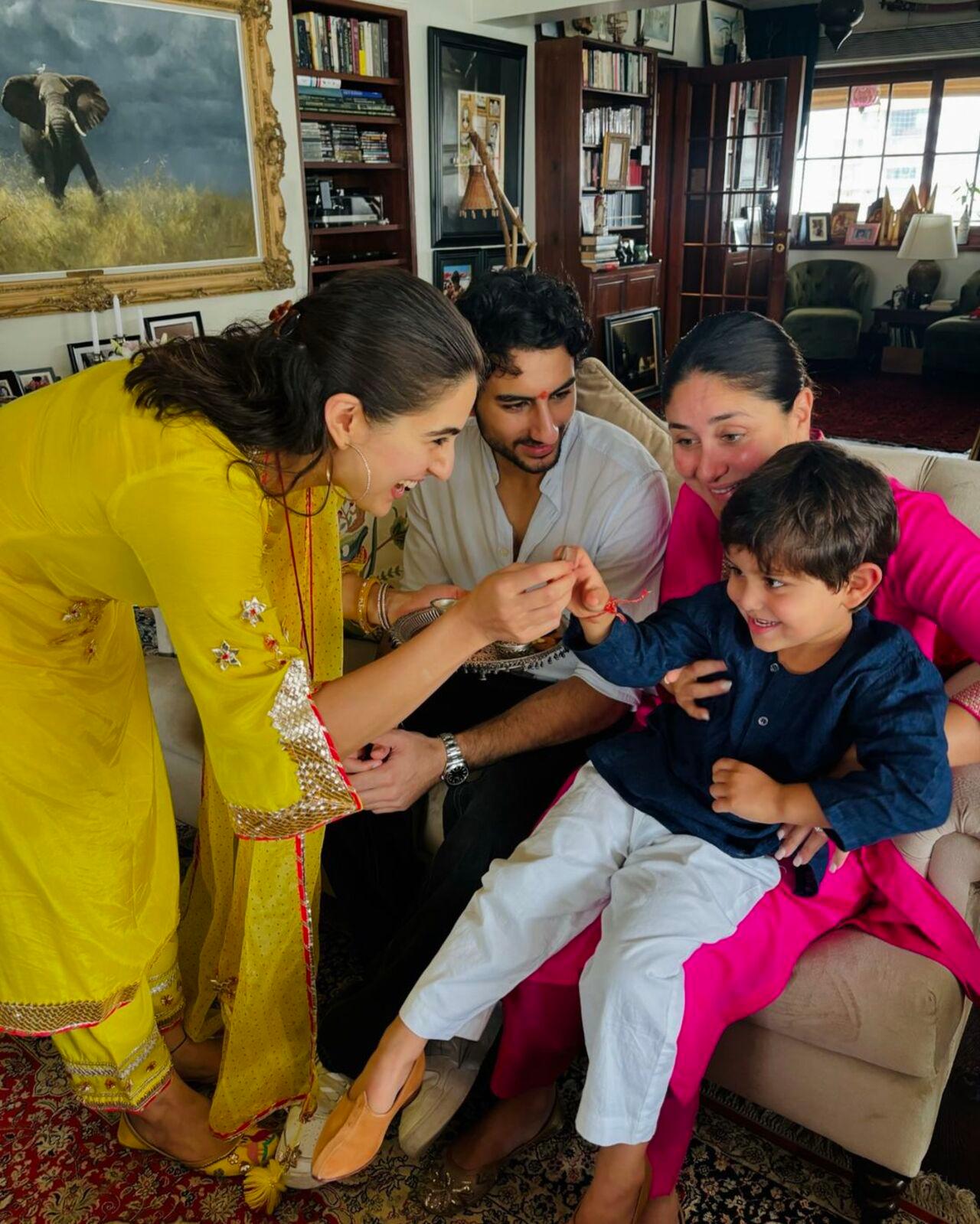 Sara ties rakhi to half-brother Jeh as the little one sits on Kareena's lap