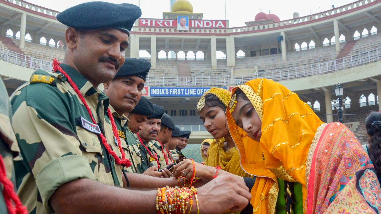 Women tie rakhi on wrists of a Border Security Force (BSF) personnel on the occasion of Raksha Bandhan festival at the India-Pakistan Attari-Wagah Border post, about 35km from Amritsar (Pic: PTI)