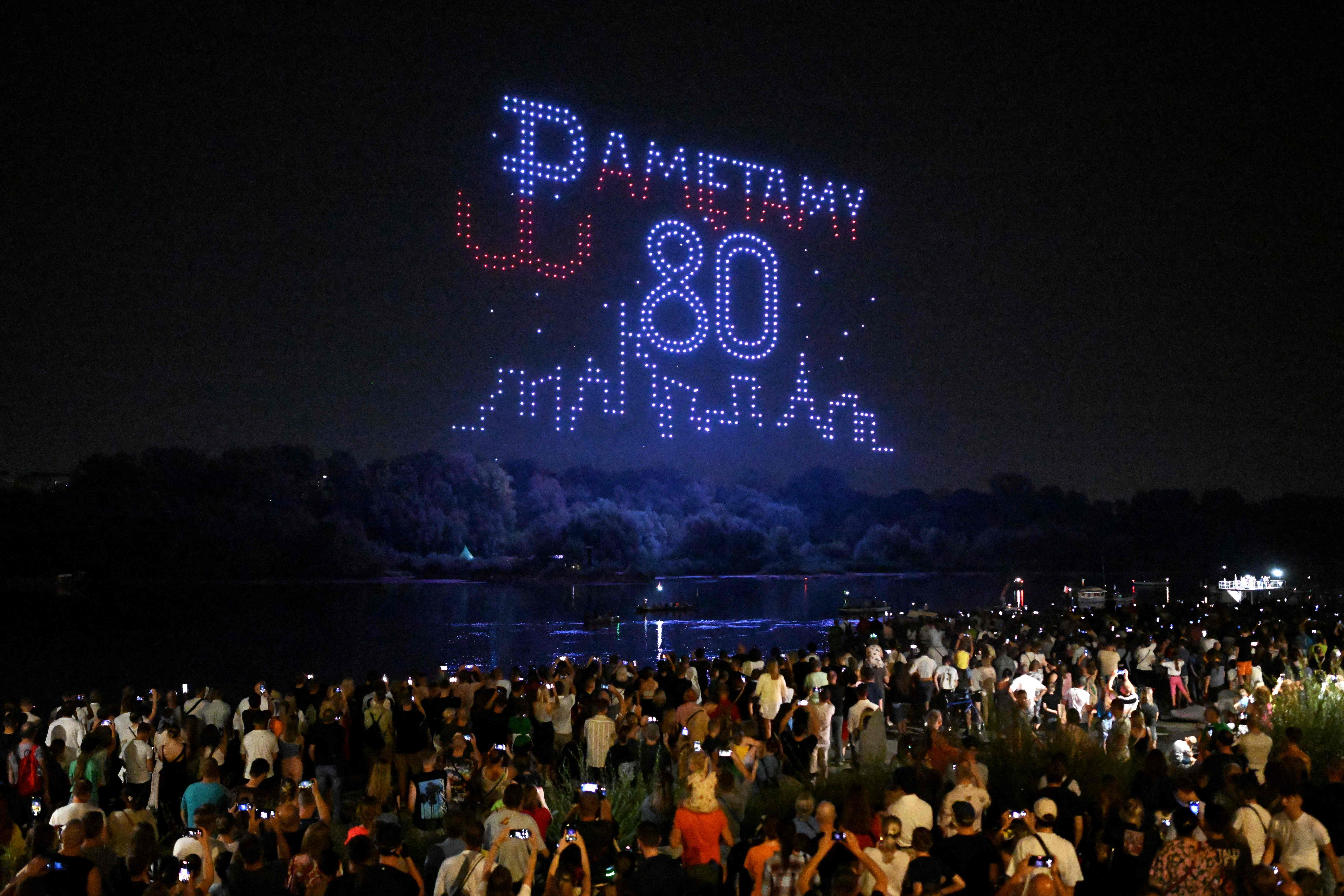 Drones form the pattern of words that read 'We remember' in Polish