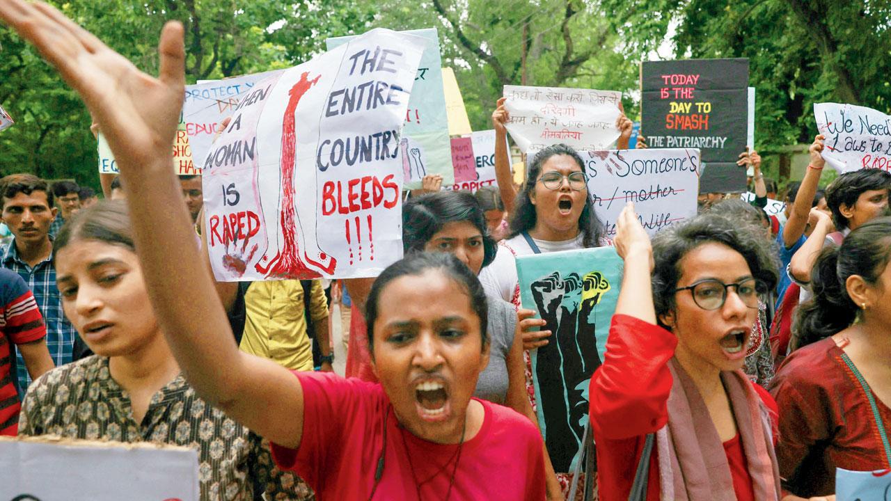 BHU students hold posters
