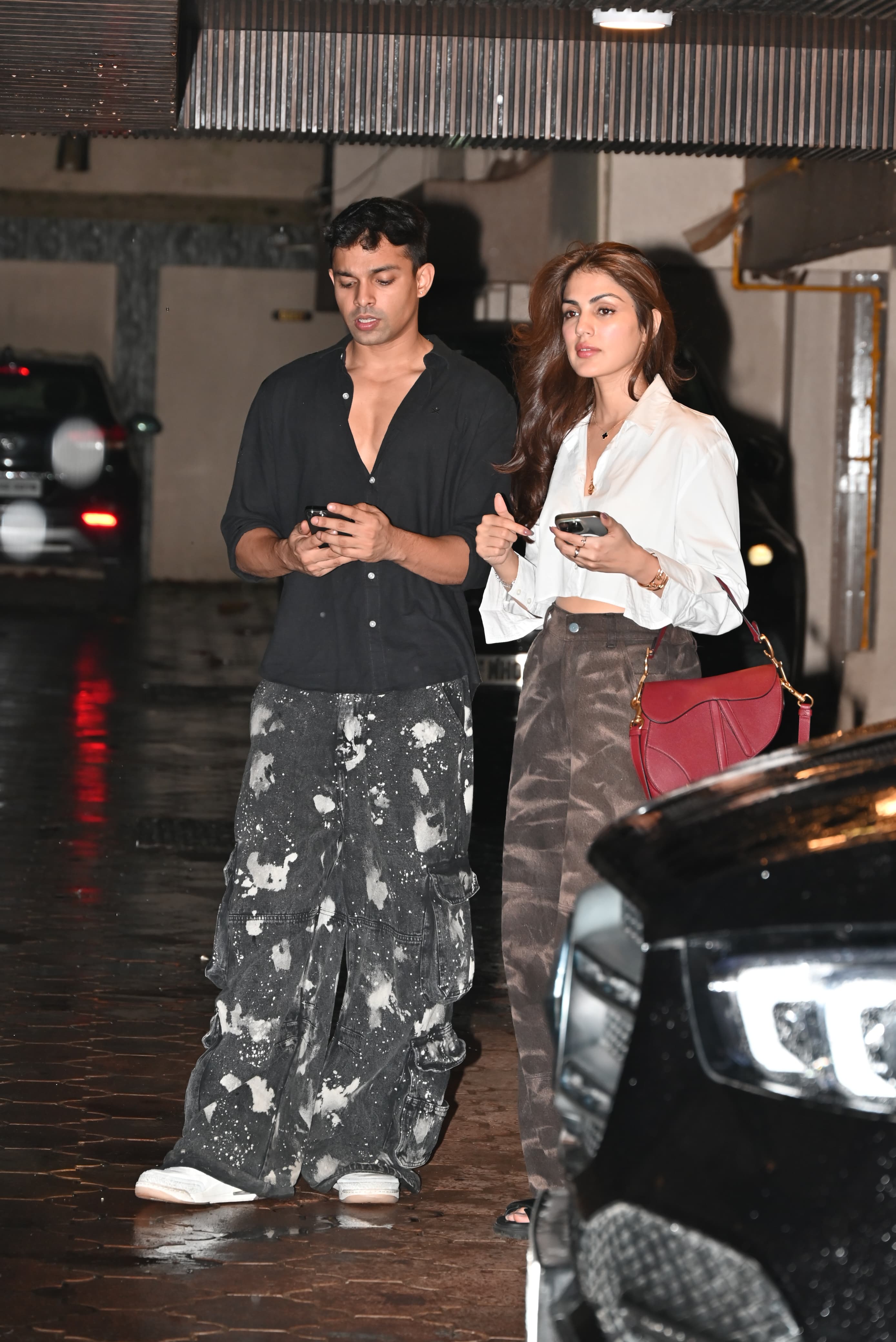 While Rhea wore a white shirt paired with military print bottoms, her brother complemented her in a black shirt paired with similar pants