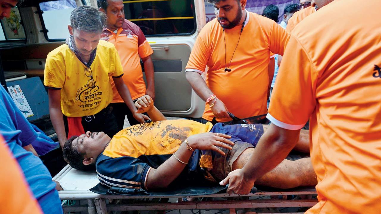 A Govinda who fell during tier formation of a pyramid being taken to KEM hospital in Parel on Tuesday. Pics/Atul Kamble