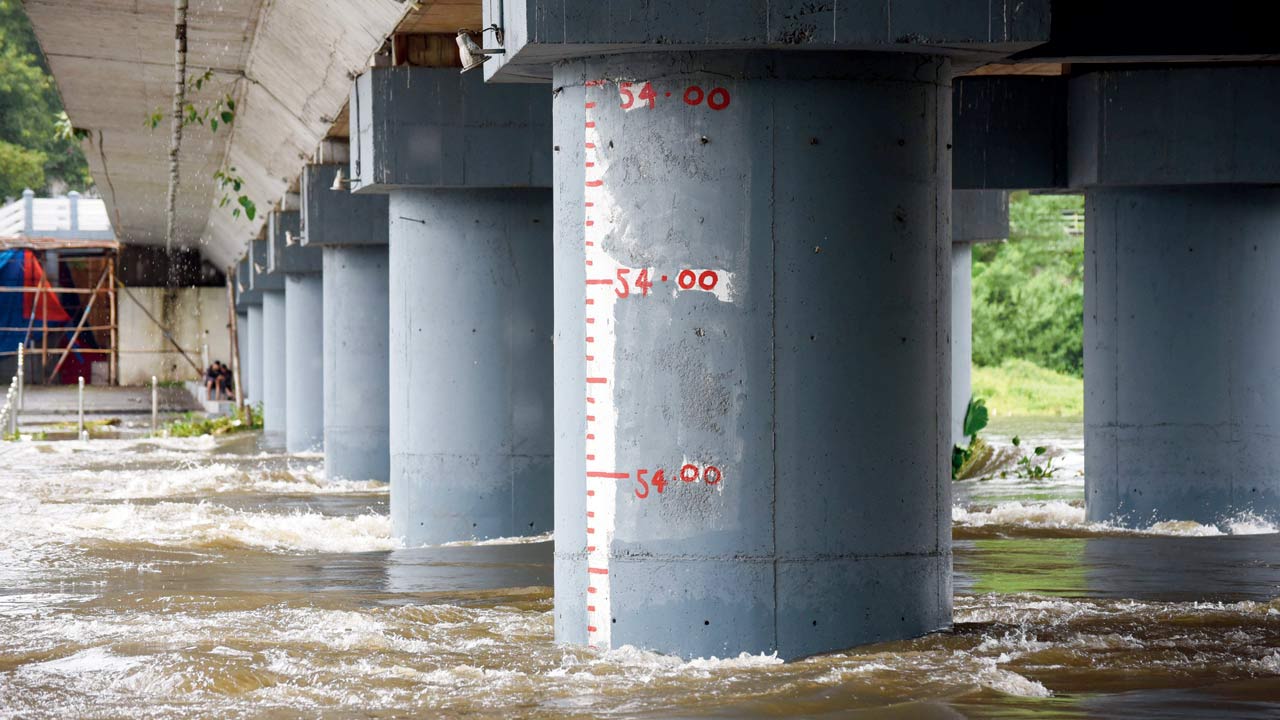 Flooded Mutha River after 13,981 cusecs water released into river from Khadakwasla dam, which filled to capacity following continuous rain, on  July 30, 2019, in Pune. History repeated itself on August 4 when 45,000  cusecs were released into the already flooded city. Pic/Getty Images