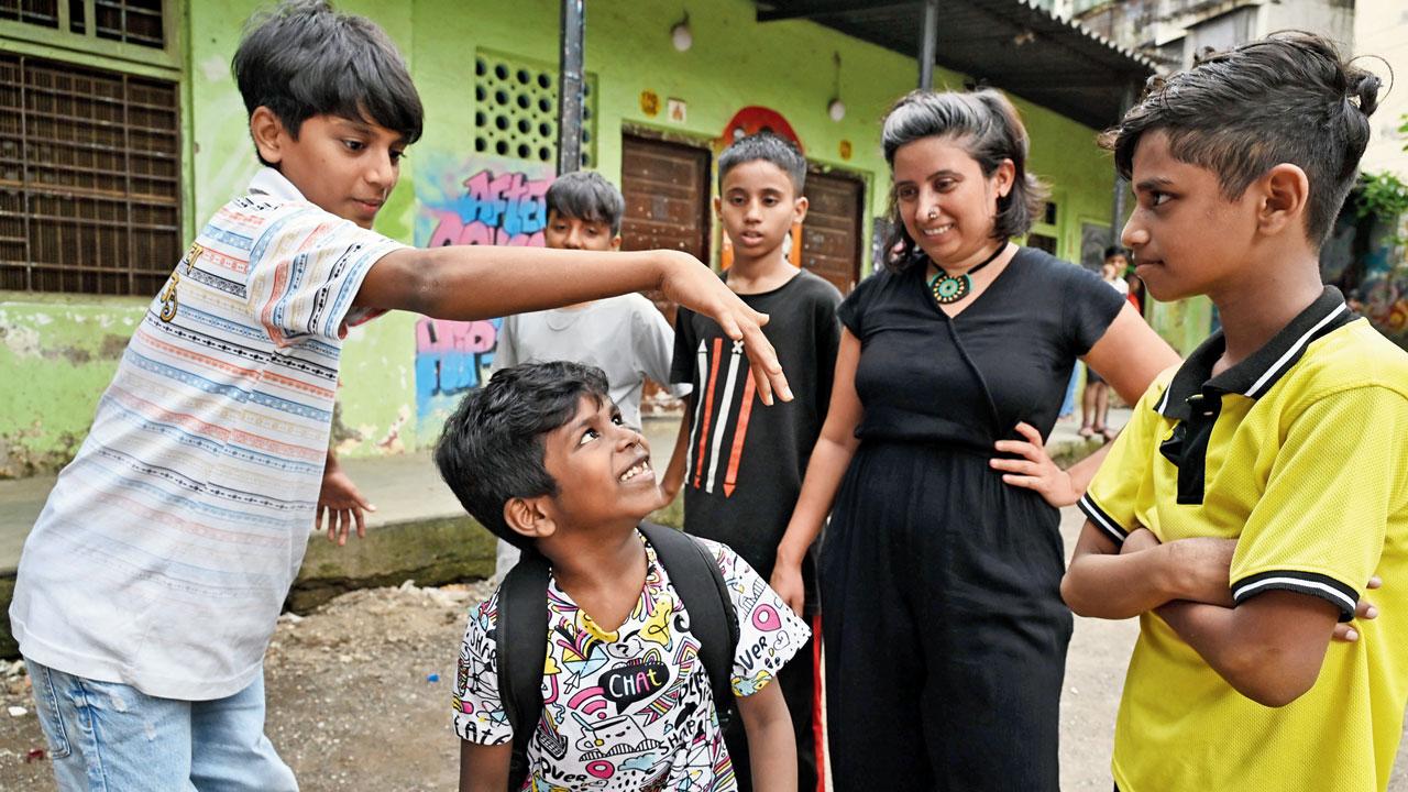 Singh oversees the rehearsal of a scene that depicts children getting lured into vices in Dharavi