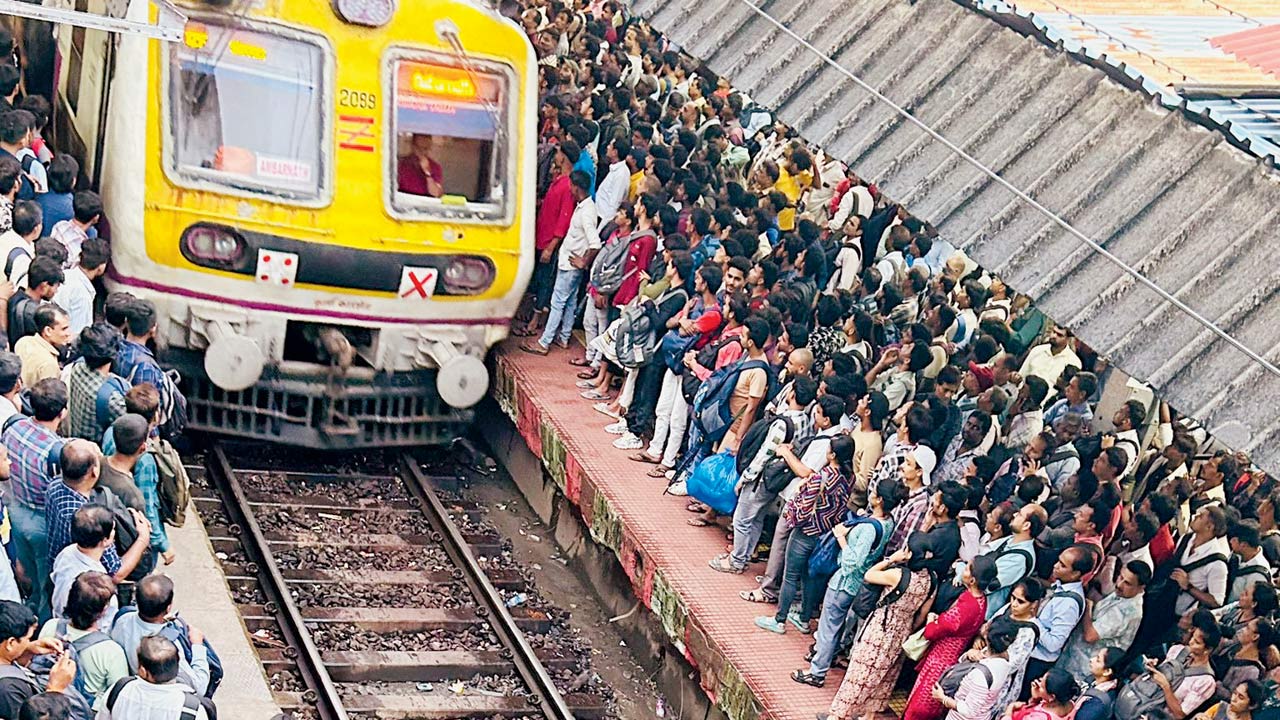 Hordes of passengers wait to board a delayed train at Dadar railway station