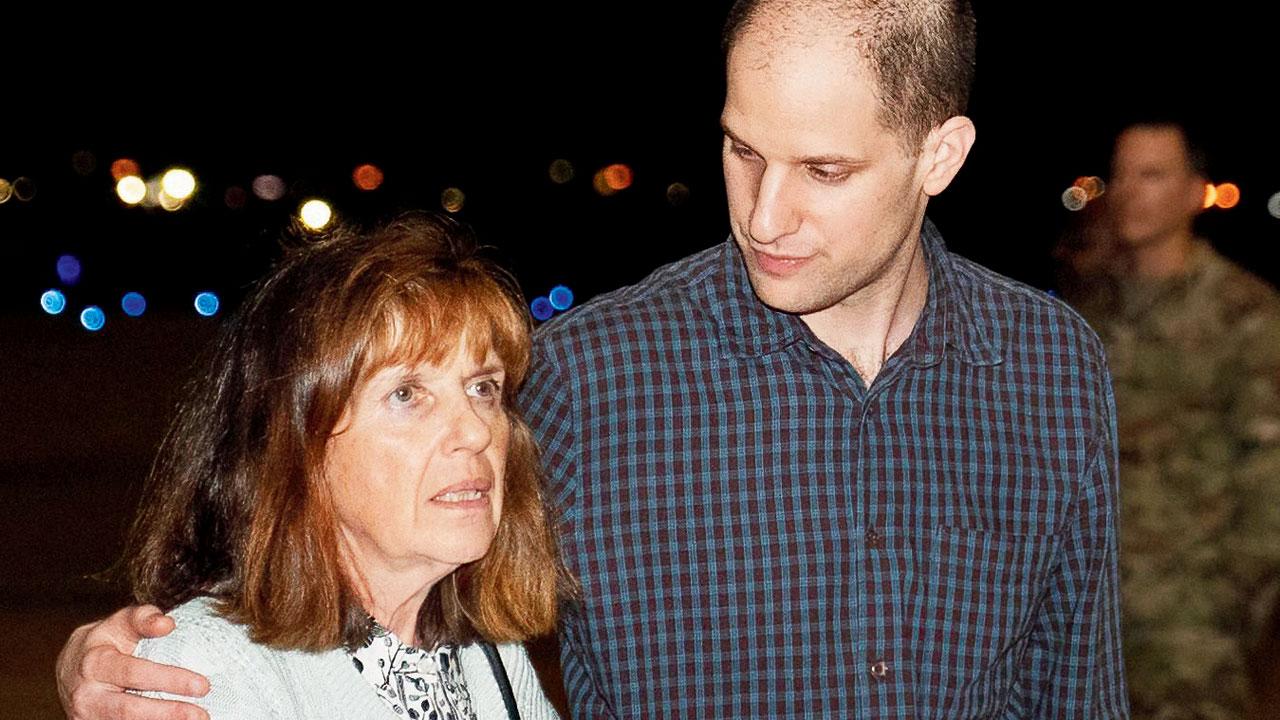 Released reporter Evan Gershkovich speaks with his mother after returning. Pics/AFP