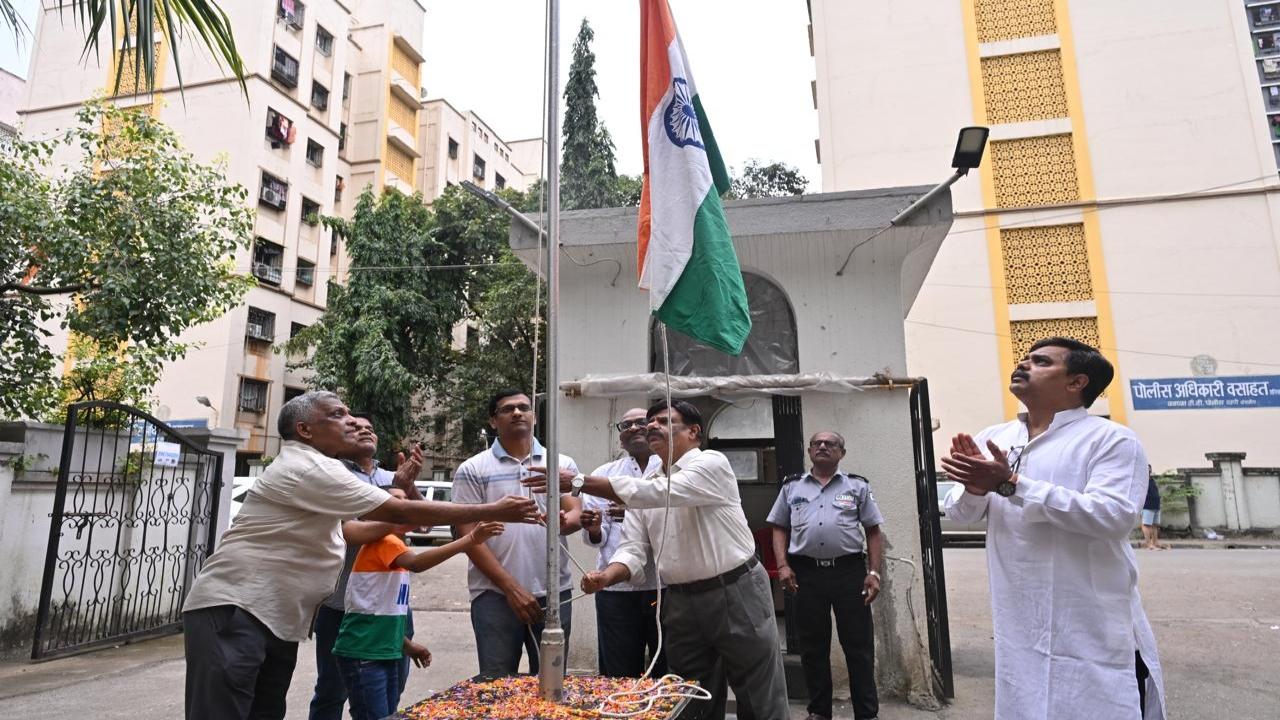 Residents hoist the flag at the Press Enclave in Sion
