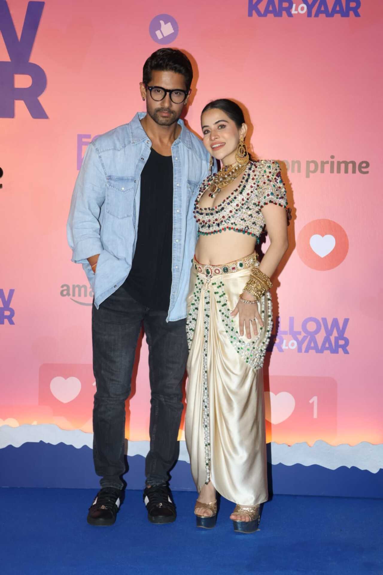 Uorfi Javed possed at the blue carpet with TV actor Ravi Dubey. The reality TV star stunned in a white heavily embroidered dress