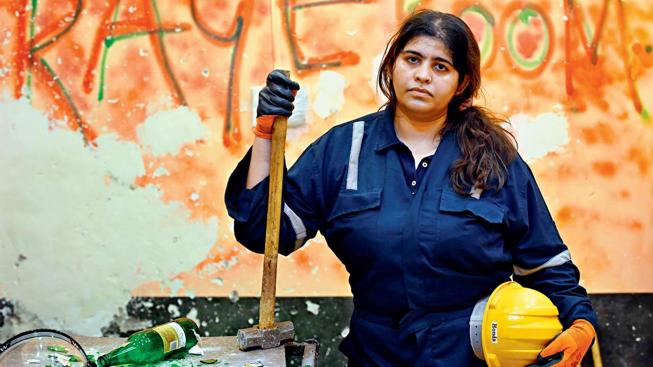 Shivani Sharma feels lighter after hammering out her frustration on glass bottles at the Rage Room in  Andheri West. Pic/Satej Shinde