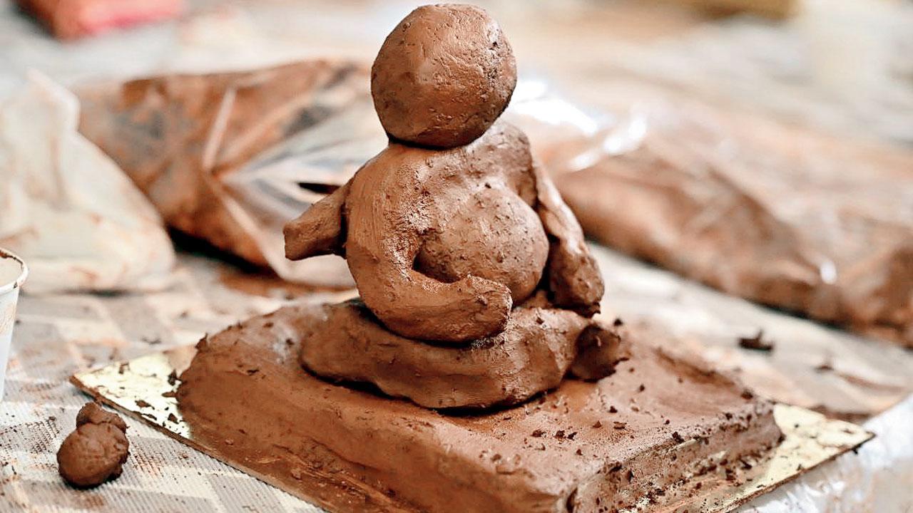 A Ganpati idol being moulded from terracotta, which dissolves in water, making it an eco-friendly material