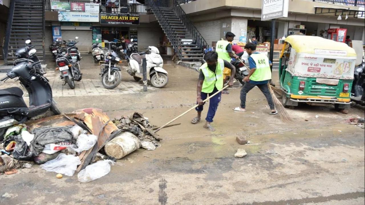 Civic workers in Vadodara clean the city. Vadodara had faced severe waterlogging in several of its residential areas owing to the downpour    