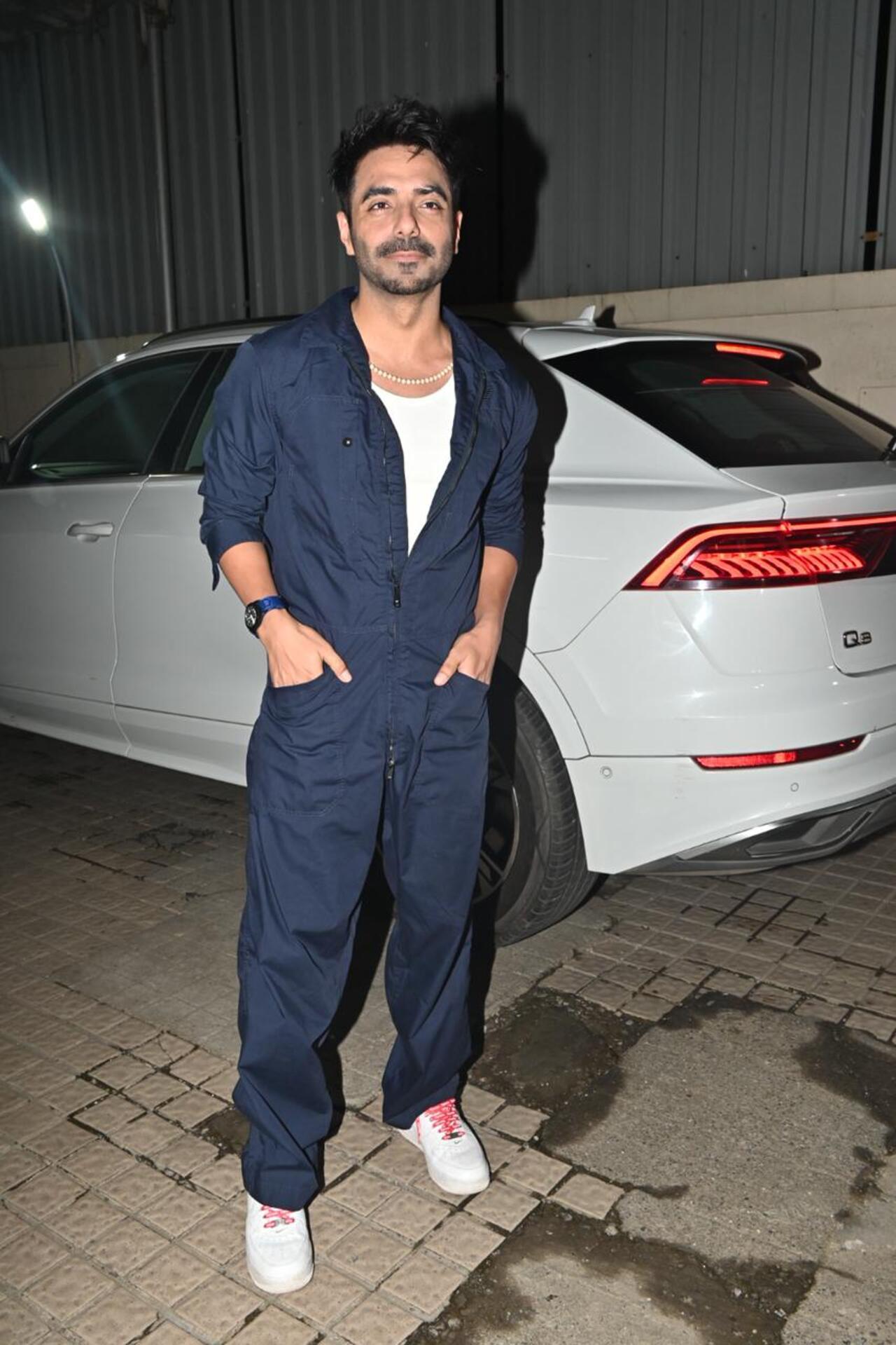 Aparshakti Khurrana posed for the cameramen stationed outside the theater