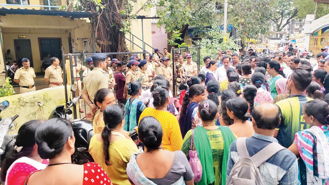 The crowd gathered outside the police station