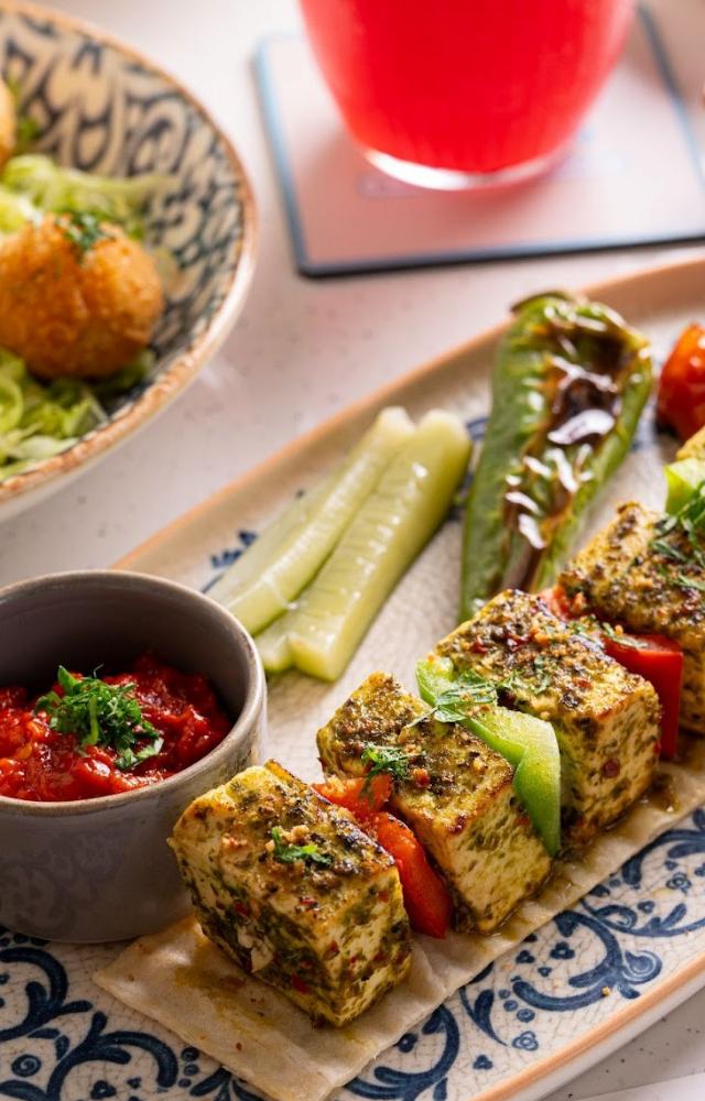 Diners can enjoy various dishes like the Chimichurri Cottage Cheese and Pepper Skewer, a grilled delight infused with zesty chimichurri