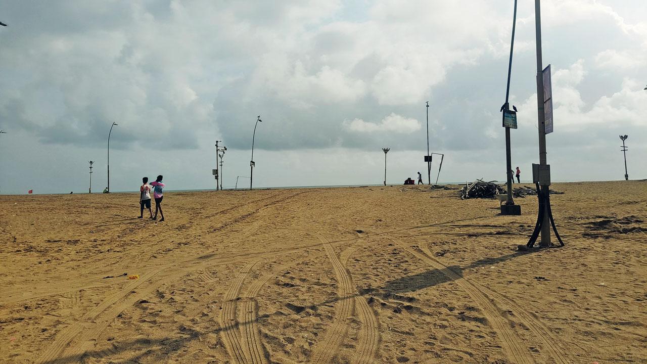 The spot where the duo was run over, with visible tyre track marks in the sand