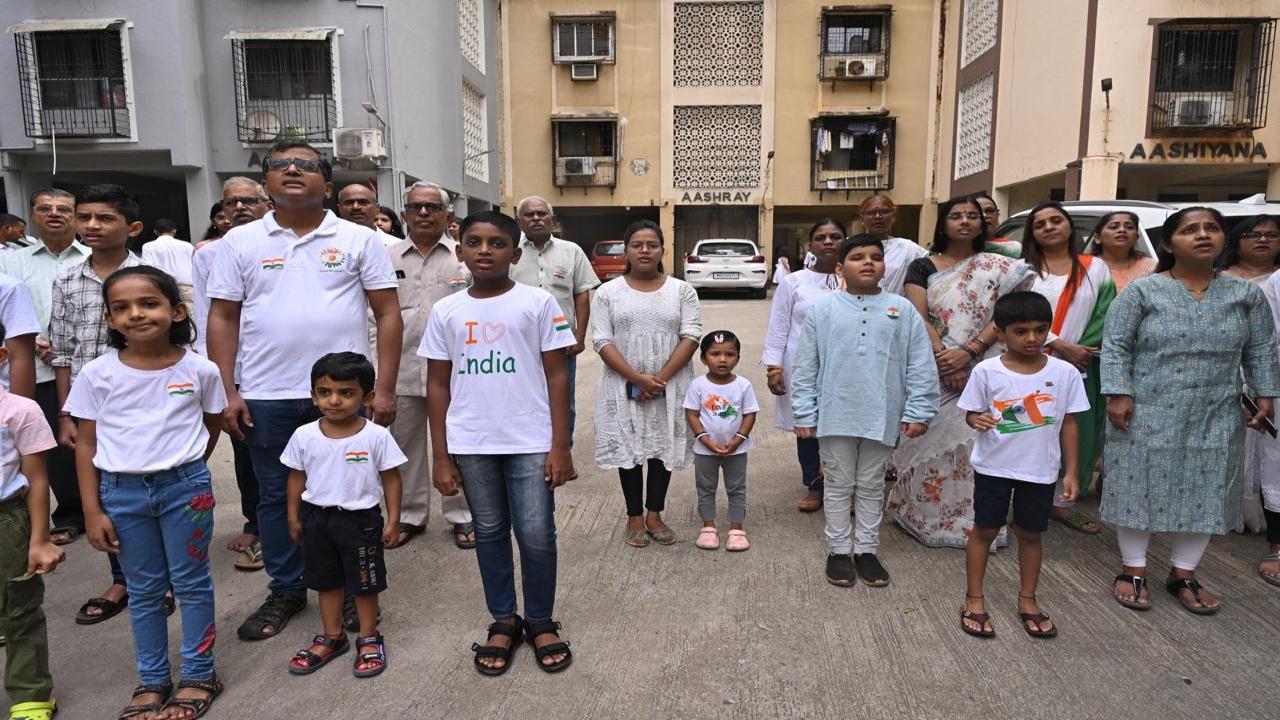 Residents participate in the flag-hoisting ceremony at Sion