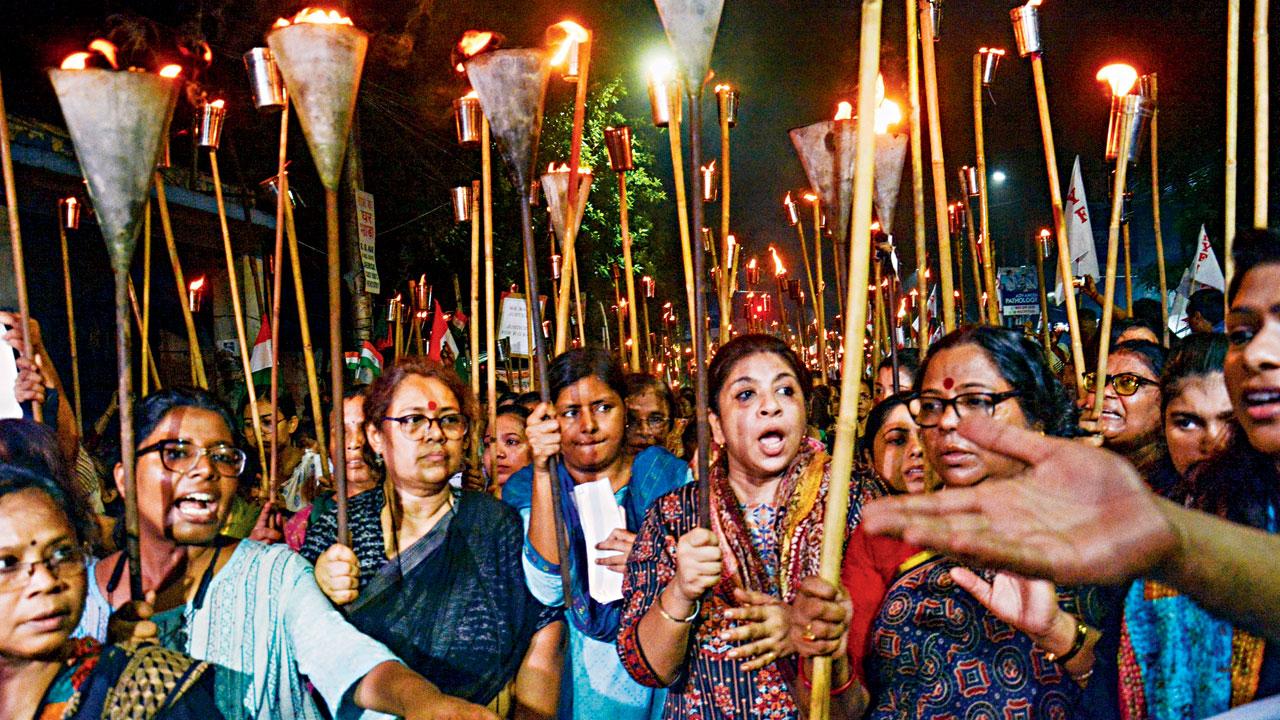 People take part in a torch rally in Kolkata