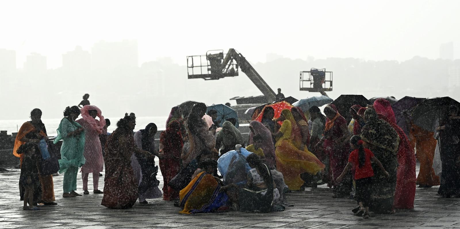 Members of the Marwari community, who were in Marine Drive for the Janmashtami rituals, enjoy the showers on Tuesday