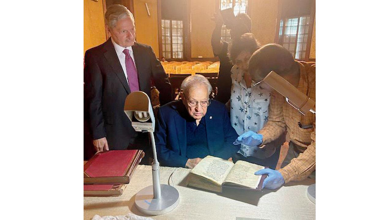 Mehta (centre) listens as Victor Joseph (right) talks about the manuscript