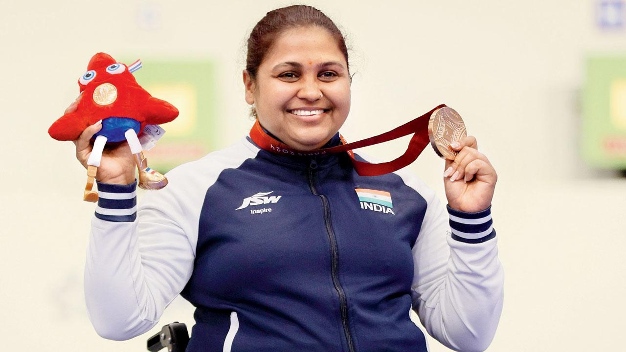 Bronze medal-winner Mona Agarwal celebrates on the podium