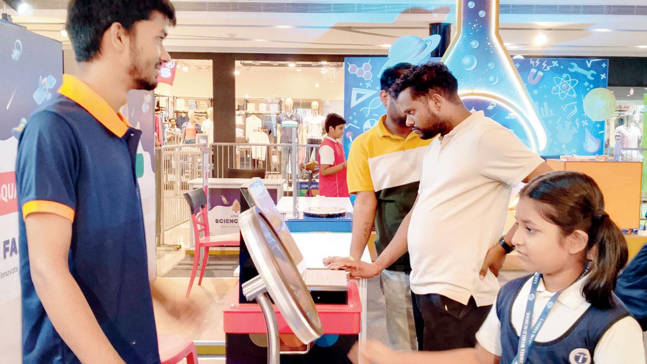 A visitor interacts with an exhibit